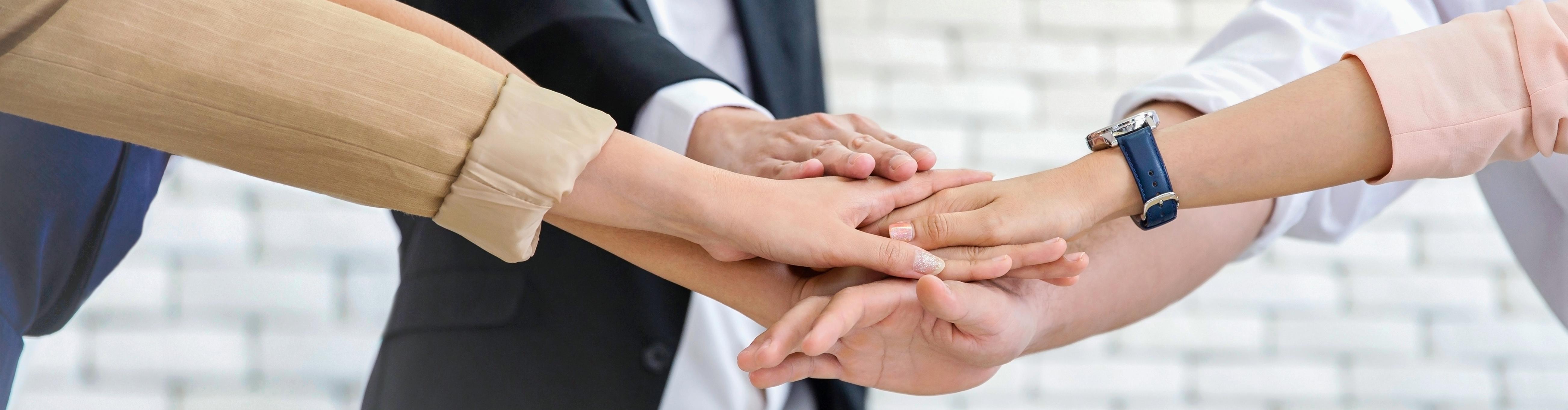 vecteezy_close-up-business-team-of-young-man-and-woman-showing-unity_8059923.jpg